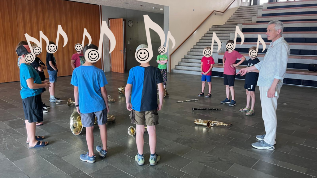 Bläserklasse an der Murnauer Realschule. Schülerinnen und Schüler stehen im Kreis. Vor jedem liegt ein Blasinstrument.